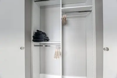 a bathroom with a mirror and a shelf with towels at Sunshine Manor 2009 in Fort Lauderdale