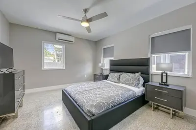 a bedroom with a bed and a dresser and a television at Sunshine Manor 2013 in Fort Lauderdale