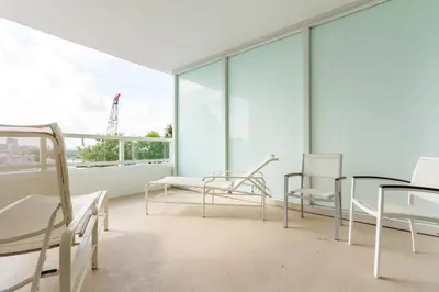 a room with chairs and tables on a balcony at Fontainebleau in Miami Beach