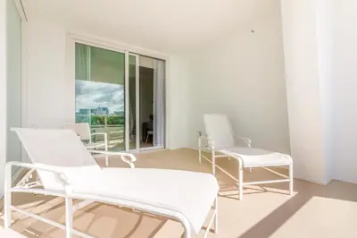 a room with white chairs and a window at Fontainebleau in Miami Beach