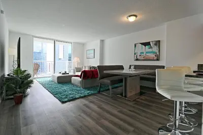 a living room with a couch and a table and chairs at Upscale Apartment in the Heart of Brickell in Miami