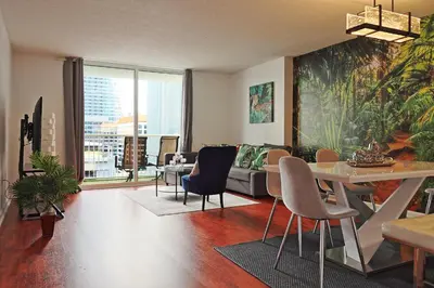 a living room with a couch and a table and chairs at Upscale Apartment in the Heart of Brickell in Miami