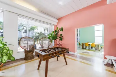 a game room with a table and chairs at Tropics Hotel Miami Beach in Miami Beach