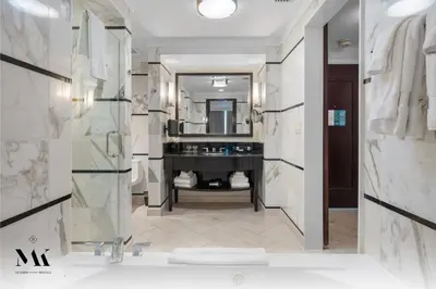 a bathroom with a tub and a sink and a mirror at FontaineBleau Resort Balcony w Ocean and City View in Miami Beach