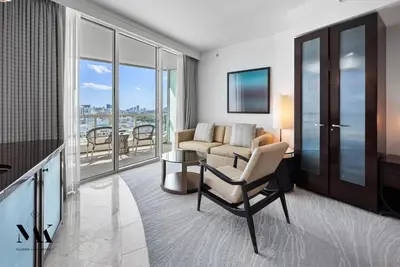 a living room with a couch and a chair at FontaineBleau Resort Ocean plus Bay View w Balcony in Miami Beach