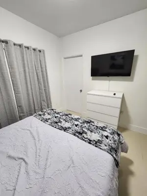 a bedroom with a bed and a tv on the wall at The 305 in Miami