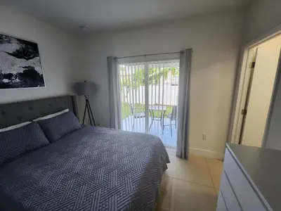 a bedroom with a bed and a door to a patio at The 305 in Miami