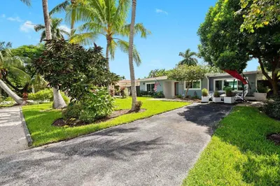 a house with palm trees and a driveway at Copacabana in Fort Lauderdale