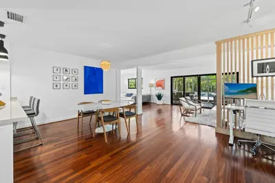 a kitchen and living room with a table and chairs at 7 Minutes to Beach Saltwater Pool Open Floor Plan in Fort Lauderdale