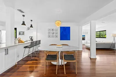 a kitchen and dining room with a table and chairs at 7 Minutes to Beach Saltwater Pool Open Floor Plan in Fort Lauderdale