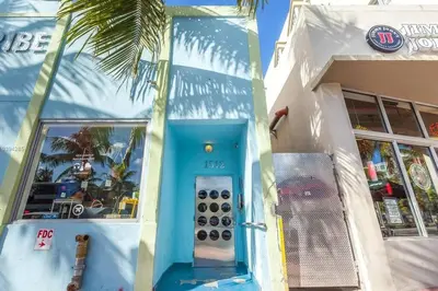 a building with a phone booth in front of it at 1 Bedroom 5 minutes walk to Beach on Washington Ave in Miami Beach
