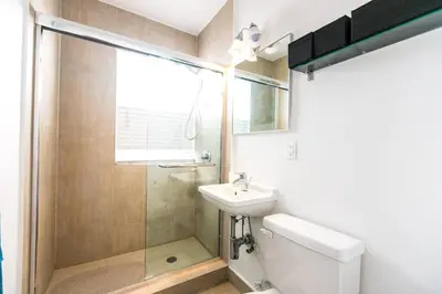a bathroom with a shower and a toilet and a sink at 1 Bedroom 5 minutes walk to Beach on Washington Ave in Miami Beach