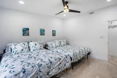 a bedroom with two beds and a ceiling fan at Villa Fiesta - Celebrate Dreams Create Memories in Southwest Ranches