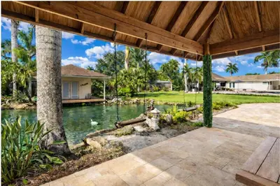 a house with a pond in a yard at Villa Fiesta - Celebrate Dreams Create Memories in Southwest Ranches