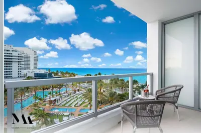 a balcony with a view of the beach and ocean at FontaineBleau Resort Balcony w Pool & Ocean View in Miami Beach