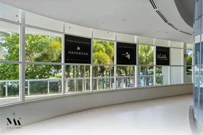 a group of windows in a building with palm trees at FontaineBleau Resort Balcony w Pool & Ocean View in Miami Beach