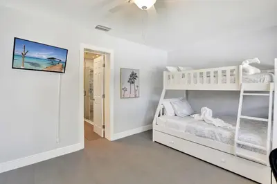 a bedroom with two bunk beds and a ceiling fan at Lakefront Family Fun Home with Private Dock 3BR 2B in Fort Lauderdale