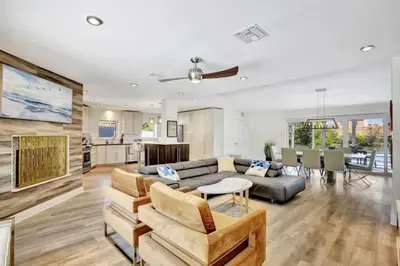 a living room with a couch and a table at Lakefront Family Fun Home with Private Dock 3BR 2B in Fort Lauderdale