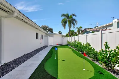 a miniature golf course in the courtyard of a house at Lakefront Family Fun Home with Private Dock 3BR 2B in Fort Lauderdale