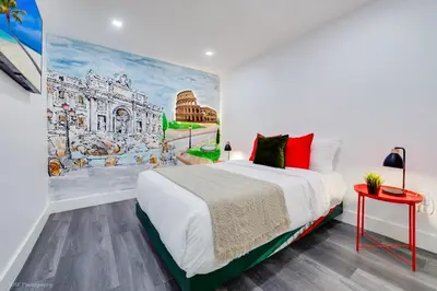a bedroom with a bed and a painting on the wall at The World's Mansion - Game Room, 9 Bedrooms, Htd Pool, Mini Golf, BBQ in Tamiami