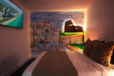 a bedroom with a large painting on the wall at The World's Mansion - Game Room, 9 Bedrooms, Htd Pool, Mini Golf, BBQ in Tamiami