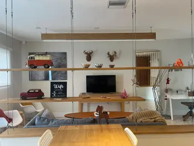 a living room with a table and a tv at Cozy house close Brickell in Miami
