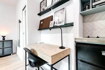 a kitchen with a table and a desk in a room at Coral Way Studio in quiet area Fast Internet Shen 1 in Miami