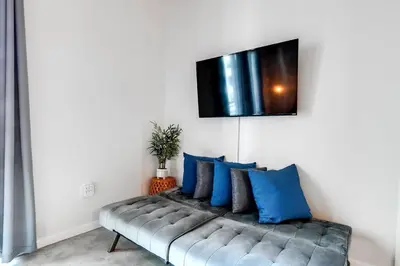 a living room with a couch with blue pillows at Super convenient 1br apartment in Downtown 4 p 1708 in Miami