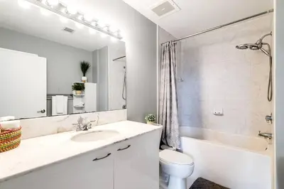 a bathroom with a sink and a toilet and a tub at Stylish 2br Apt in Downtown City View 3208 in Miami