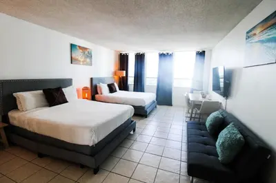 a hotel room with a bed and a couch at Castle 1205 Beachfront Studio with Free Parking, Beach Access, Pool, Tennis in Miami Beach