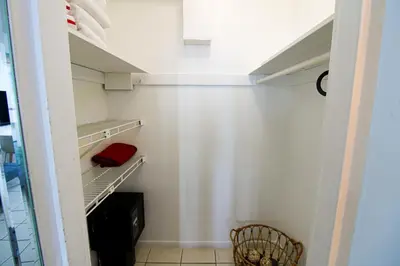a walk in closet with a red pillow on a shelf at Castle 1205 Beachfront Studio with Free Parking, Beach Access, Pool, Tennis in Miami Beach