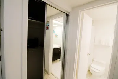 a bathroom with a toilet and a mirror at Castle 1205 Beachfront Studio with Free Parking, Beach Access, Pool, Tennis in Miami Beach