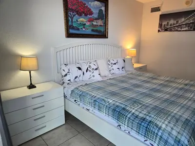 a bedroom with a bed and a dresser and lamp at Ocean Reserve in Sunny Isles Beach