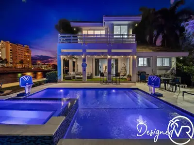 a villa with a swimming pool at night at Villa wpool spa game room in Hollywood