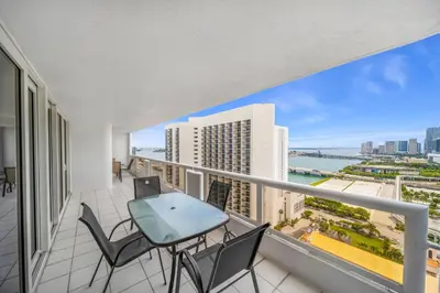 a balcony with a table and chairs and a view of the city at The Grand Wonder in Miami