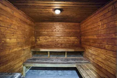 an empty wooden sauna with a bench in it at The Grand Wonder in Miami