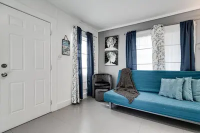 a blue couch in a room with a window at Welcoming 2-BR apartment - 6 people V1 in Miami