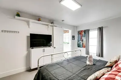 a bedroom with a bed and a flat screen tv at Welcoming 2-BR apartment - 6 people V1 in Miami
