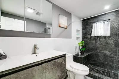 a bathroom with a white toilet and a sink at Welcoming 2-BR apartment - 6 people V1 in Miami