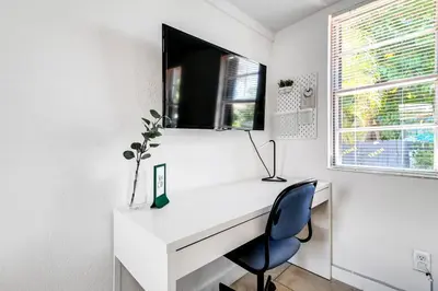 a white desk with a chair and a window at Inviting 1-BR apartment for 4 people V2 in Miami