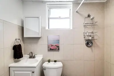 a bathroom with a sink and a toilet and a window at Inviting 1-BR apartment for 4 people V2 in Miami
