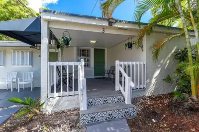 a house with a white gate and a porch at Captivating 2-BR apartment for 5 people V3 in Miami