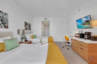 a living room with a couch and a table at To Steps from the Beach - Coastal Bliss, Pool- Gym in Hallandale Beach