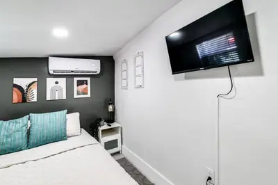 a bedroom with a bed and a flat screen tv at Miami studio apartment, Very centric, Fast Wi-Fi V4 in Miami