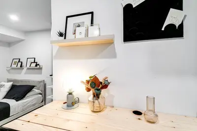 a living room with a table and a bed at Wonderful Studio Cottage 2 people V5 in Miami