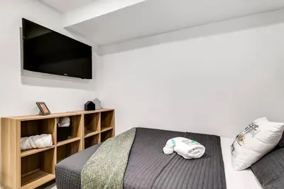 a bedroom with a bed and a flat screen tv at Wonderful Studio Cottage 2 people V5 in Miami