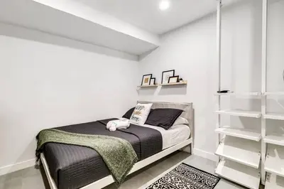 a bedroom with a bed and white walls at Wonderful Studio Cottage 2 people V5 in Miami