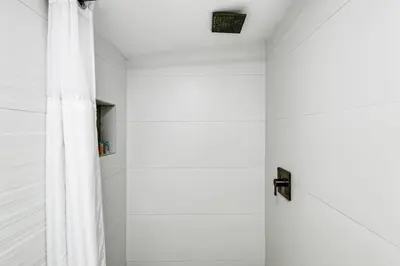 a shower with a white shower curtain in a bathroom at Swinging London Studio 3 people V6 in Miami