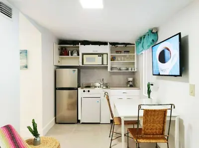 a kitchen with white appliances and a table and chairs at Swinging London Studio 3 people V6 in Miami