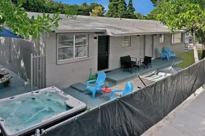 a small house with a hot tub on a patio at Wynwood Bungalow Hottub & Pking in Miami